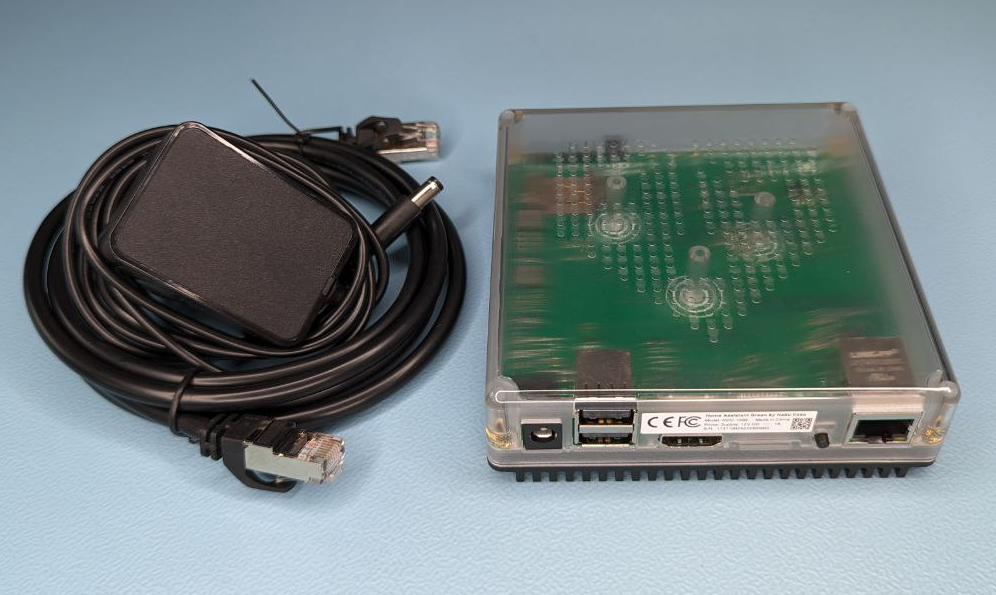 Image showing the Home Assistant Green with power supply and Ethernet cable